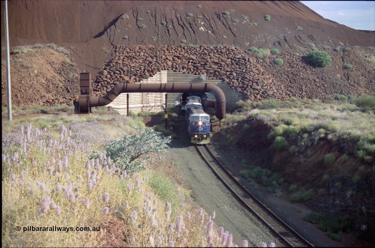 221-26
Yandi One mine loadout balloon loop, General Electric AC6000 class emerges from the loadout portal at 0.9 km/h as it leads a train through the loading vaults, the dust extraction ducting is also visible.
Keywords: GE;AC6000;51062-9;