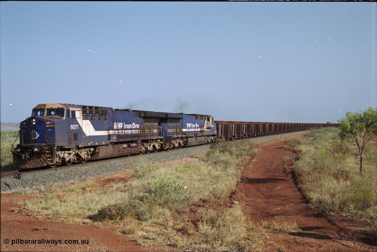 222-03
At the 105.7 km grade crossing near Gillam Siding, a loaded Yandi train approaches behind two General Electric AC6000 units built by GE at their Erie plant, BHP 6071 serial 51063 leads sister unit 6074, 6071 has not been named as yet. This road was also the original road into Lynas Find Gold Project, back in the day. [url=https://goo.gl/maps/7emwhQdnBN32]GeoData[/url].
Keywords: 6071;GE;AC6000;51063;