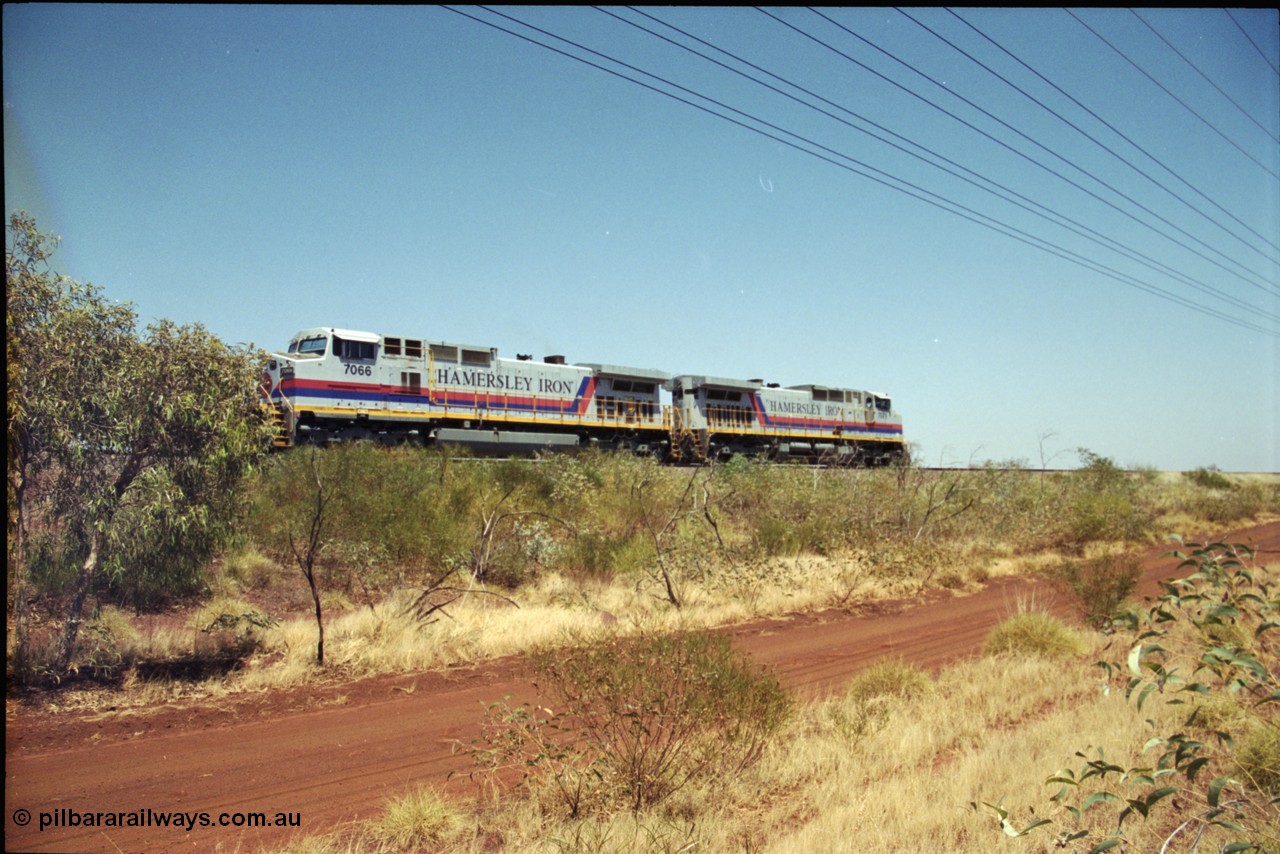 222-18
Somewhere on the original single line section between Gull and Rosella Hamersley Iron 7066 serial 47745 a General Electric Dash 9-44CW built by GE at Erie brings a loaded train to a stand with 7071 for a crew change.
Keywords: 7066;GE;Dash-9-44CW;47745;