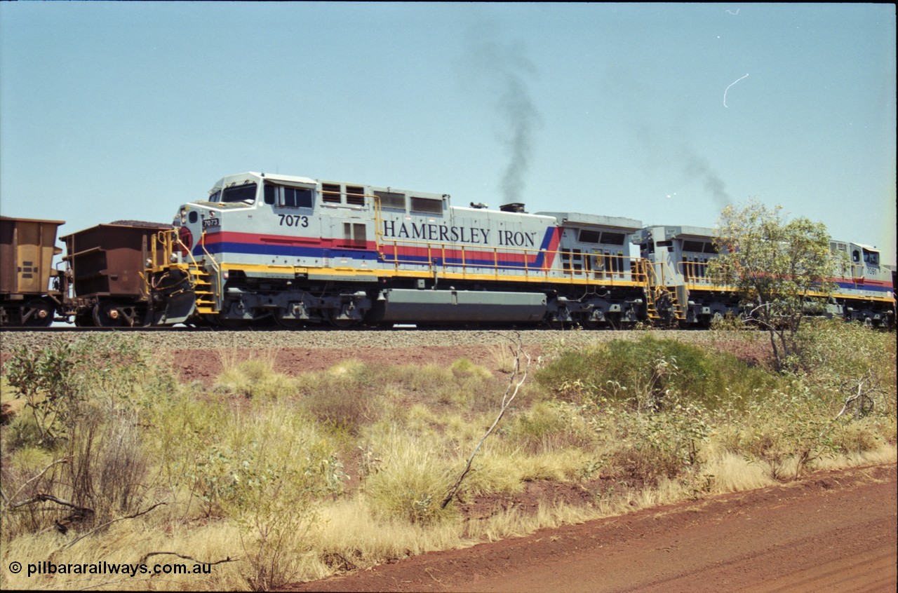 222-29
Somewhere on the original single line section between Gull and Rosella Hamersley Iron 7073 serial 47752 a General Electric Dash 9-44CW built by GE at Erie powers away with an empty train with 7091 following a crew change with a loaded train.
Keywords: 7073;GE;Dash-9-44CW;47752;