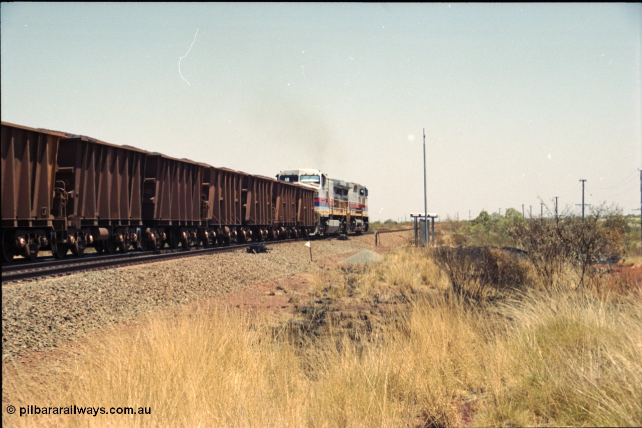 222-35
Somewhere on the original single line section between Gull and Rosella a pair of Hamersley Iron General Electric Dash 9-44CW's built by GE at Erie power a loaded train towards Dampier from the passing track back onto the mainline following a crew change.

