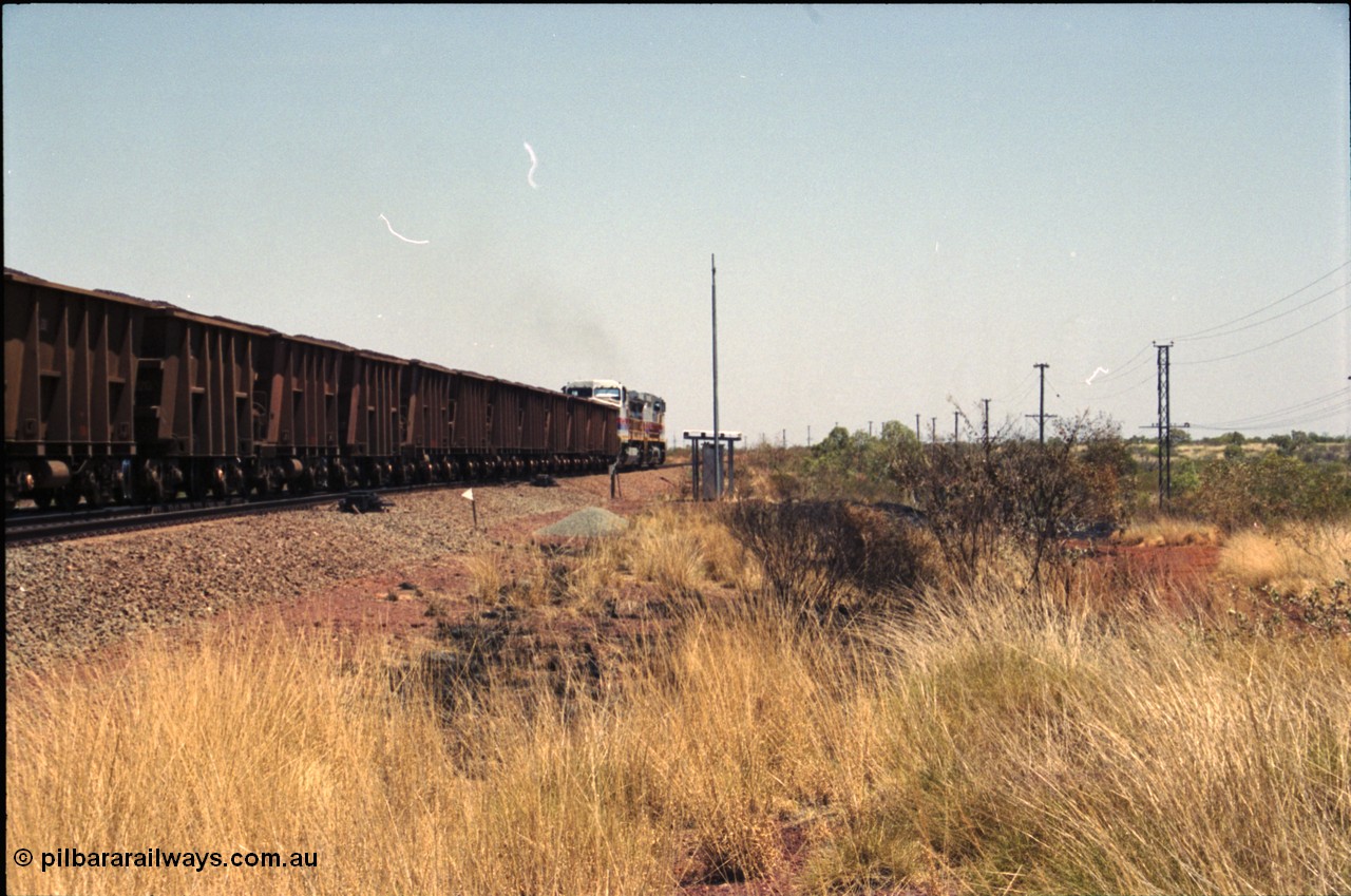 222-36
Somewhere on the original single line section between Gull and Rosella a pair of Hamersley Iron General Electric Dash 9-44CW's built by GE at Erie power a loaded train towards Dampier from the passing track back onto the mainline following a crew change.
