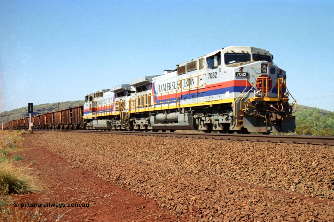 223-13
Possum Siding, Hamersley Iron loco 7082 a General Electric built Dash 9-44CW serial 47761 leads sister unit 7080 with an empty train just inside the loop waiting to effect a crew change. 21st October 2000.
Keywords: 7082;GE;Dash-9-44CW;47761;