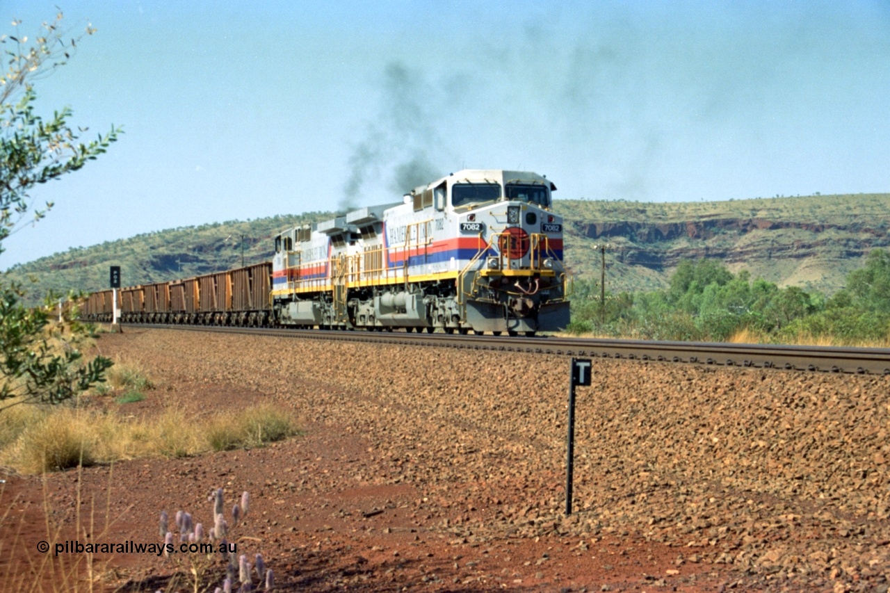 223-23
Possum Siding, Hamersley Iron loco 7082 a General Electric built Dash 9-44CW serial 47761 leads sister unit 7080 with an empty train as they power up to pull forward inside the loop to effect a crew change. 21st October 2000.
Keywords: 7082;GE;Dash-9-44CW;47761;