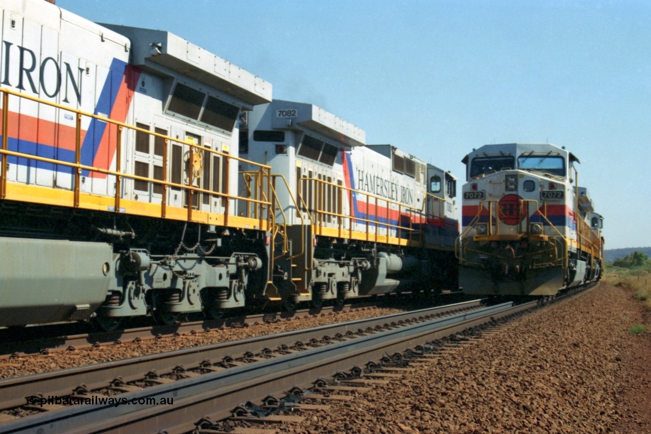 223-30
Possum Siding, a loaded train behind a pair of Hamersley Iron General Electric built Dash 9-44CW units 7072 serial 47751 and 7074 serial 47753 with the crew change completed, the empty is starting to roll on the passing track. 21st October 2000.
Keywords: 7072;GE;Dash-9-44CW;47751;