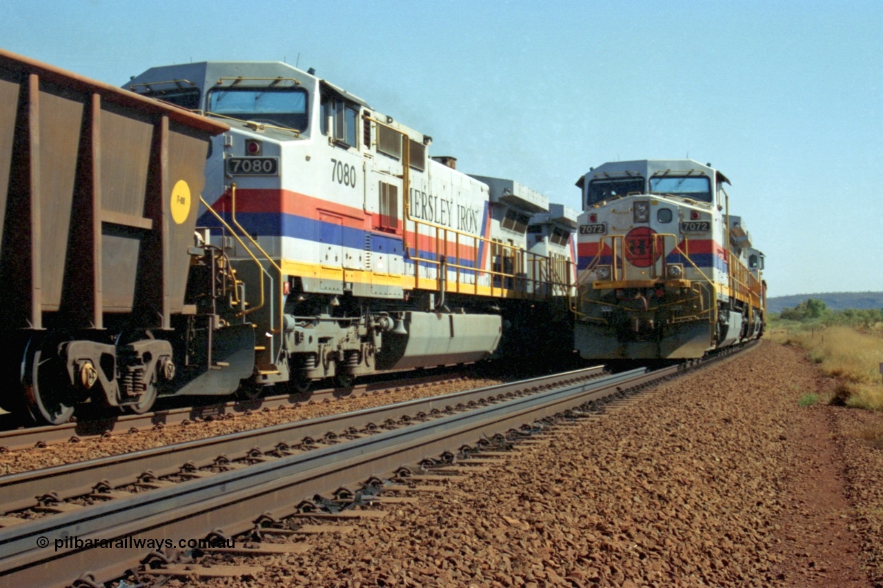 223-31
Possum Siding, a loaded train behind a pair of Hamersley Iron General Electric built Dash 9-44CW units 7072 serial 47751 and 7074 serial 47753 with the crew change completed, the empty is starting to roll on the passing track. 21st October 2000.
Keywords: 7072;GE;Dash-9-44CW;47751;