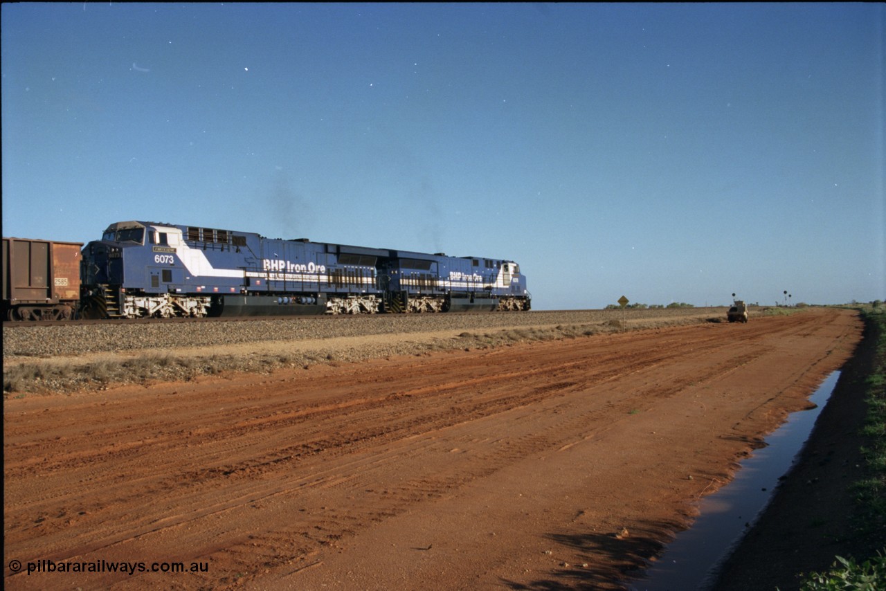 224-20
Bing siding, the afternoon empty to Yandi was a staple of the AC6000 units when delivered, operating the train as a pair, 112 waggons, AC6000 and 112 waggons. 6076 'Mt Goldsworthy' serial 51068 a General Electric AC6000 built by GE at Erie awaits the road to depart south with sister unit 6073. [url=https://goo.gl/maps/KQrczNpVhAH2]GeoData[/url].
Keywords: 6073;GE;AC6000;51065;