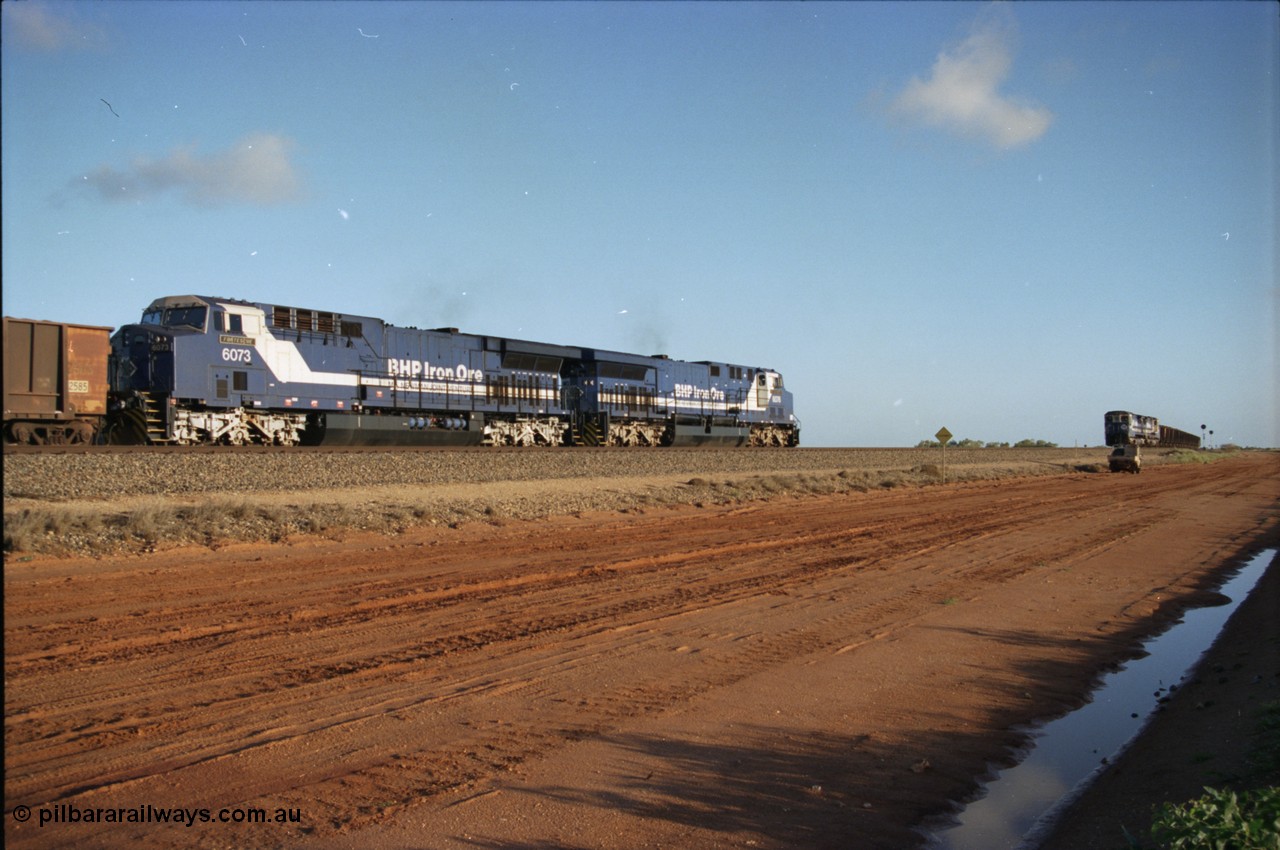 224-21
Bing siding, the afternoon empty to Yandi was a staple of the AC6000 units when delivered, operating the train as a pair, 112 waggons, AC6000 and 112 waggons. 6076 'Mt Goldsworthy' serial 51068 a General Electric AC6000 built by GE at Erie awaits the road to depart south with sister unit 6073 as a loaded behind two CM40-8M units rolls through on the mainline. [url=https://goo.gl/maps/KQrczNpVhAH2]GeoData[/url].
Keywords: 6073;GE;AC6000;51065;