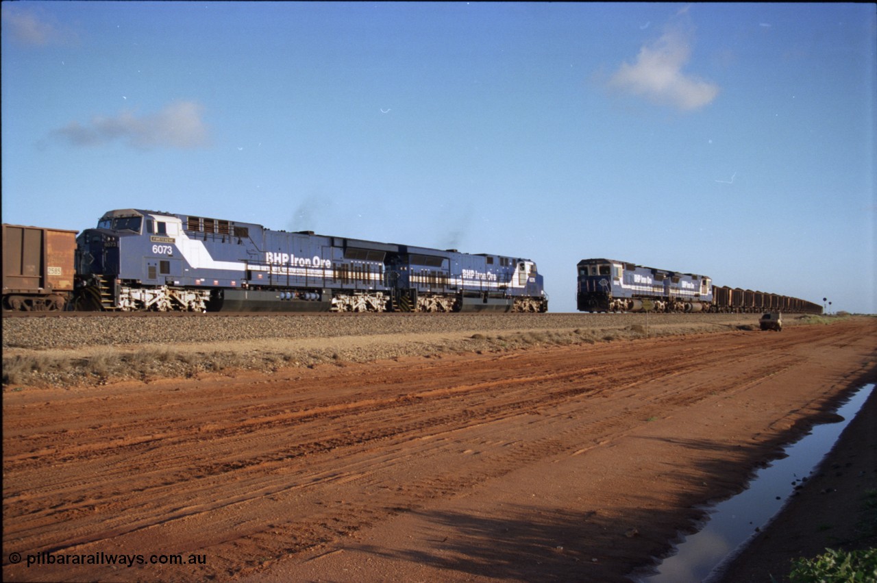224-24
Bing siding, the afternoon empty to Yandi was a staple of the AC6000 units when delivered, operating the train as a pair, 112 waggons, AC6000 and 112 waggons. 6076 'Mt Goldsworthy' serial 51068 a General Electric AC6000 built by GE at Erie awaits the road to depart south with sister unit 6073 as a loaded behind two CM40-8M units rolls through on the mainline. [url=https://goo.gl/maps/KQrczNpVhAH2]GeoData[/url].
Keywords: 6073;GE;AC6000;51065;