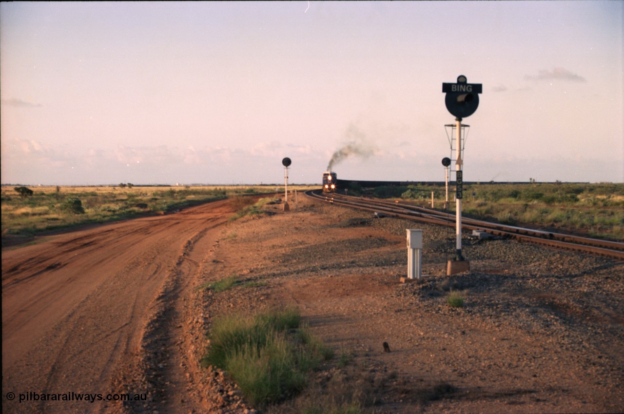 224-30
Bing siding, the afternoon empty to Yandi was a staple of the AC6000 units when delivered, operating the train as a pair, 112 waggons, AC6000 and 112 waggons. 6076 'Mt Goldsworthy' serial 51068 a General Electric AC6000 built by GE at Erie departs the loop south with sister unit 6073. [url=https://goo.gl/maps/KQrczNpVhAH2]GeoData[/url].
