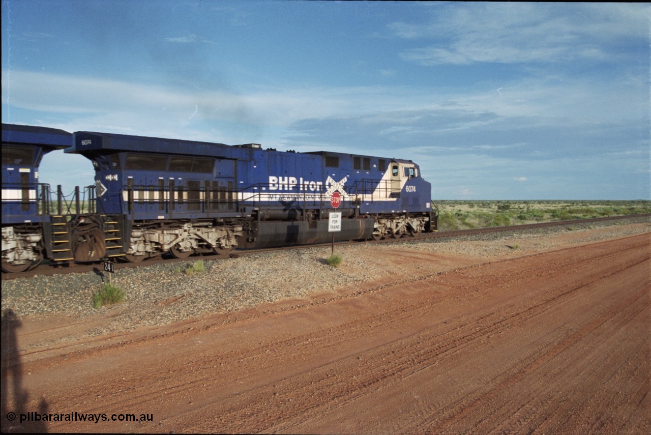 225-20
At the 24.1 km grade crossing on the BHP Newman line, General Electric AC6000 model unit 6074 serial 51066 built at GE Erie leads the afternoon empty Yandi mine train as it heads south. This was before the units were named. [url=https://goo.gl/maps/qGkyfiuy6212]GeoData[/url].
Keywords: 6074;GE;AC6000;51066;