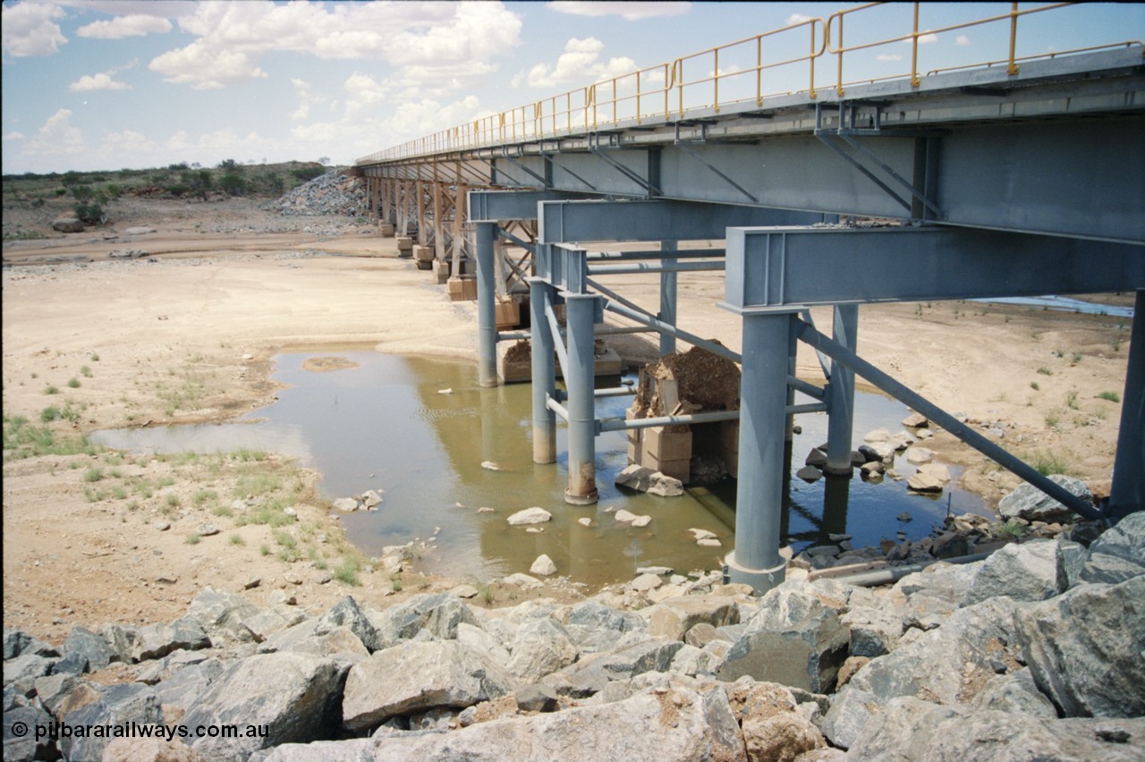 226-03
Yule River bridge showing new piles and deck to replace flood damaged piles after a cyclone that closed the line for two weeks in the late 1990s. [url=https://goo.gl/maps/G67Mat23u4P2]GeoData[/url].
