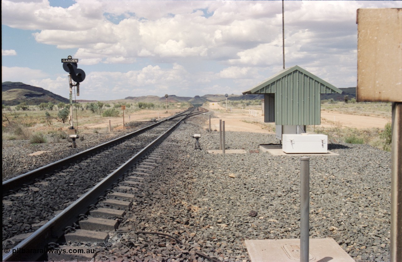 226-11
Garden Siding looking north from the south end. Signal post with dual heads, GNS 3 and GNS 3R which is a repeater signal aimed up the hill for loaded trains running down grade. The small units each side of the mainline is a Cold Wheel Detector. As the trains are running down a 5 km long 1.5 percent grade the trains are under dynamic and train brake control to maintain the train speed below the limit. [url=https://goo.gl/maps/GhqKW3xWJPq]GeoData[/url].

