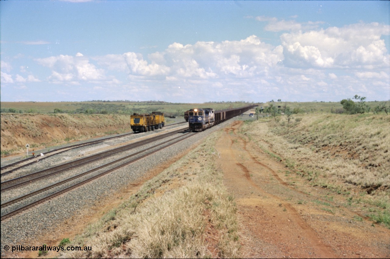 226-23
Shaw siding at the 219 km a loaded train with standard double CM40-8M power blasts along the mainline with the rear portion still on a .55 percent grade as it passes the Speno rail grinder in the back track. [url=https://goo.gl/maps/JLjSYskHScU2]GeoData[/url].
