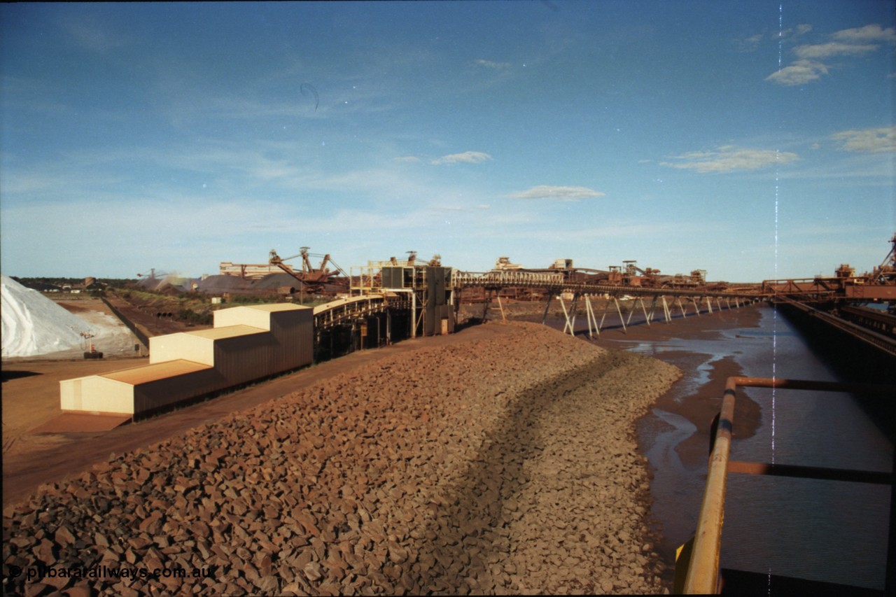 227-07
Nelson Point, view along the rear of A and B berths from Shiploader 2, salt pile on the left, then the under harbour tunnel portal, old reclaimers 3 and 4 with the crushing building in the distance, which has now been demolished, and the rear of Shiploader 1 on B berth. [url=https://goo.gl/maps/1sLxDMF5tZu]GeoData[/url].
