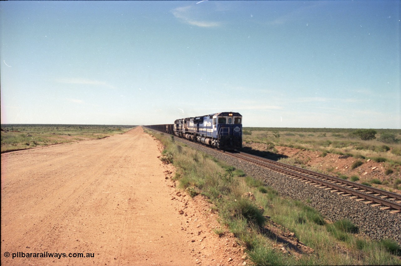 227-22
30 km area on the Newman mainline, east of the original Quarry 1, an empty train powers along the gentle .17% rising grade behind Goninan CM40-8M GE rebuilds 5649 'Pohang' serial 8412-07/93-140 and 5651 with third unit an General Electric AC6000. [url=https://goo.gl/maps/BY7Zz4F5t822]GeoData[/url].
Keywords: 5649;Goninan;GE;CM40-8M;8412-07/93-140;rebuild;AE-Goodwin;ALCo;M636C;5473;G6047-5;