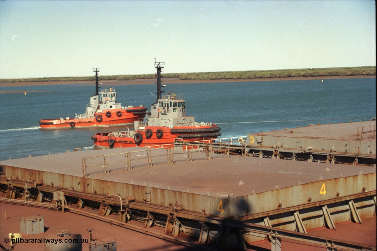 227-37
Nelson Point, tug boat Warilla, 50 ton bollard pull Z-Peller type, built by Tamar Steel Boats in Launceston in 1982, pulls a loaded carrier clear of B berth as a sister vessel Warang passes behind.
