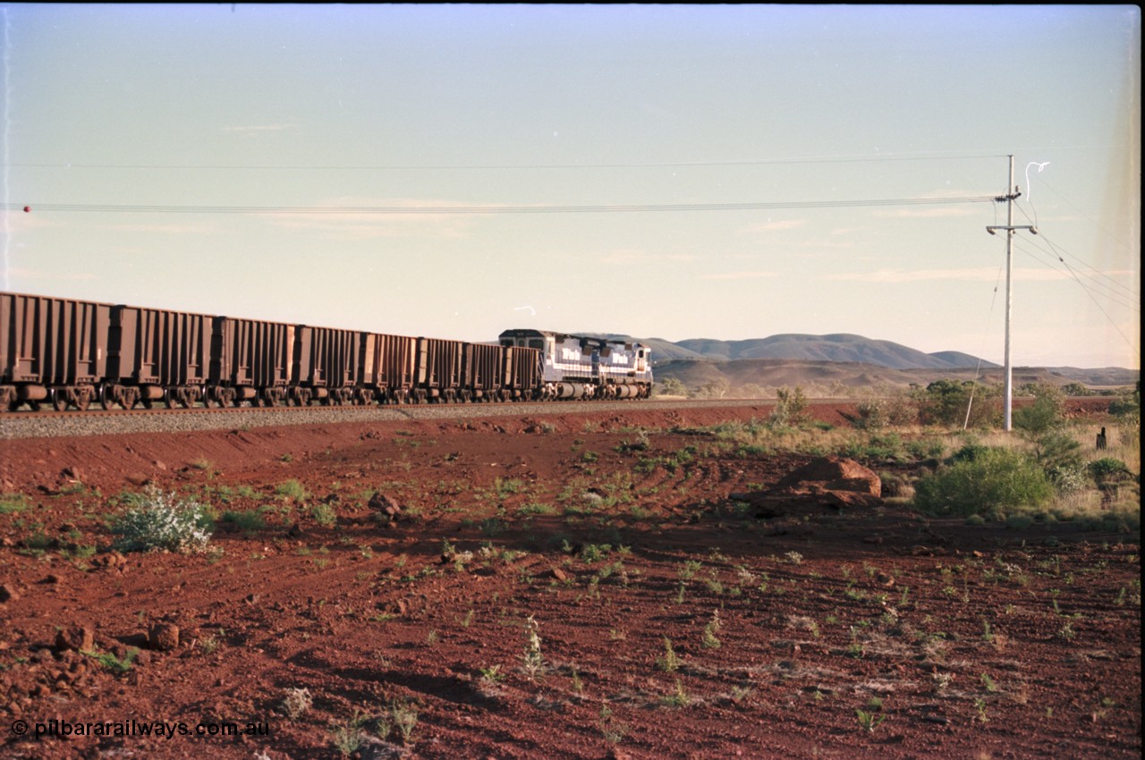 228-21
Yandi Two branch, trailing shot of the afternoon empty train heading west to the load-out behind a standard pair of Goninan rebuilt GE CM40-8M model units 5649 'Pohang' serial 8412-07/93-140 and 5644 'Kangan' serial 8281-09/92-133. Geodata [url=https://goo.gl/maps/S1bX3ycGXqE2] -22.706976, 119.097651 [/url].
Keywords: 5649;Goninan;GE;CM40-8M;8412-07/93-140;rebuild;AE-Goodwin;ALCo;M636C;5473;G6047-5;