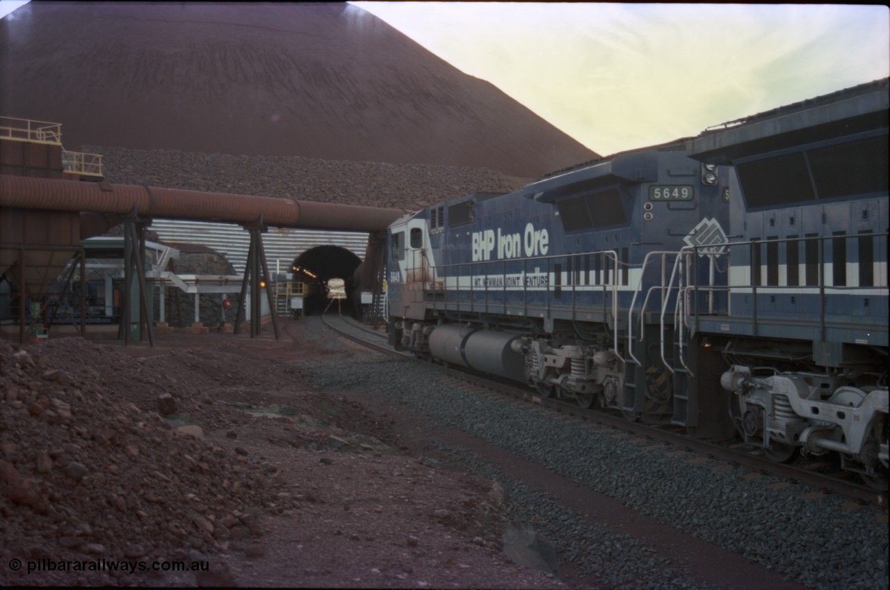 228-29
Yandi Two load-out tunnel, view of empty train about to enter for loading behind a standard pair of Goninan rebuilt GE CM40-8M model units 5649 'Pohang' serial 8412-07/93-140 and 5644 'Kangan' serial 8281-09/92-133. Geodata [url=https://goo.gl/maps/KbzBN9Bt4k52] -22.720824, 119.043410 [/url].
Keywords: 5649;Goninan;GE;CM40-8M;8412-07/93-140;rebuild;AE-Goodwin;ALCo;M636C;5473;G6047-5;