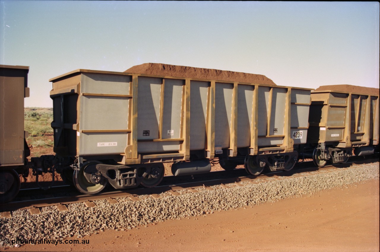 230-33
Yandi Two balloon loop, Goninan new build ore car 4239, build date of June 1997 from the original United Goninan WA order for 126 units with a tapered floor. Tare weight of 23.3 tonnes, loaded with Yandi Fines ore. Geodata [url=https://goo.gl/maps/h68ia1caJvL2] -22.718338, 119.039909 [/url].
Keywords: 4239;Comeng-WA;BHP-ore-waggon;
