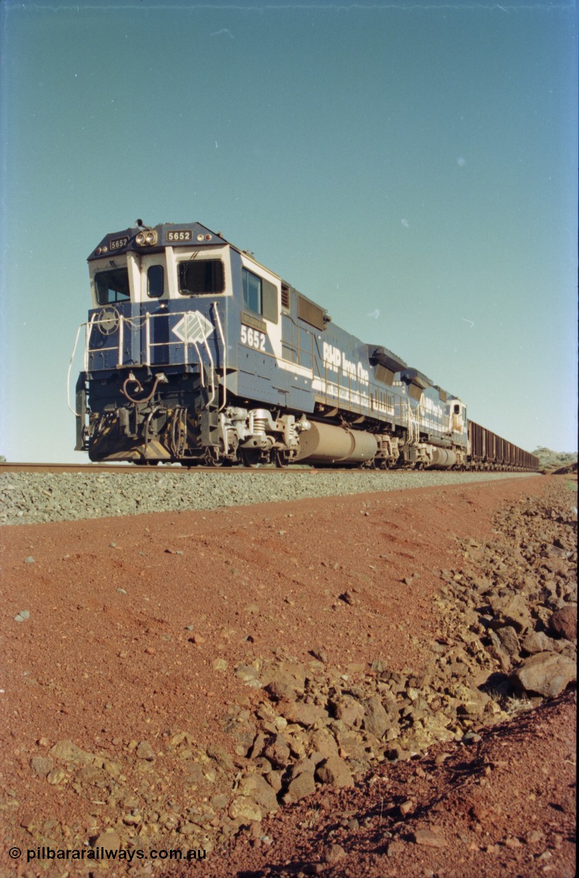 231-13
Yandi Two balloon loop, BHP Iron Ore 5652 'Villanueva' serial 8412-09 / 93-143 an Goninan WA rebuild CM40-8M GE unit loads a train at 1.2 km/h with second unit 5650. [url=https://goo.gl/maps/3vQHZqBXNa32]GeoData[/url].
Keywords: 5652;Goninan;GE;CM40-8M;8412-09/93-143;rebuild;AE-Goodwin;ALCo;M636C;5482;G6061-3;