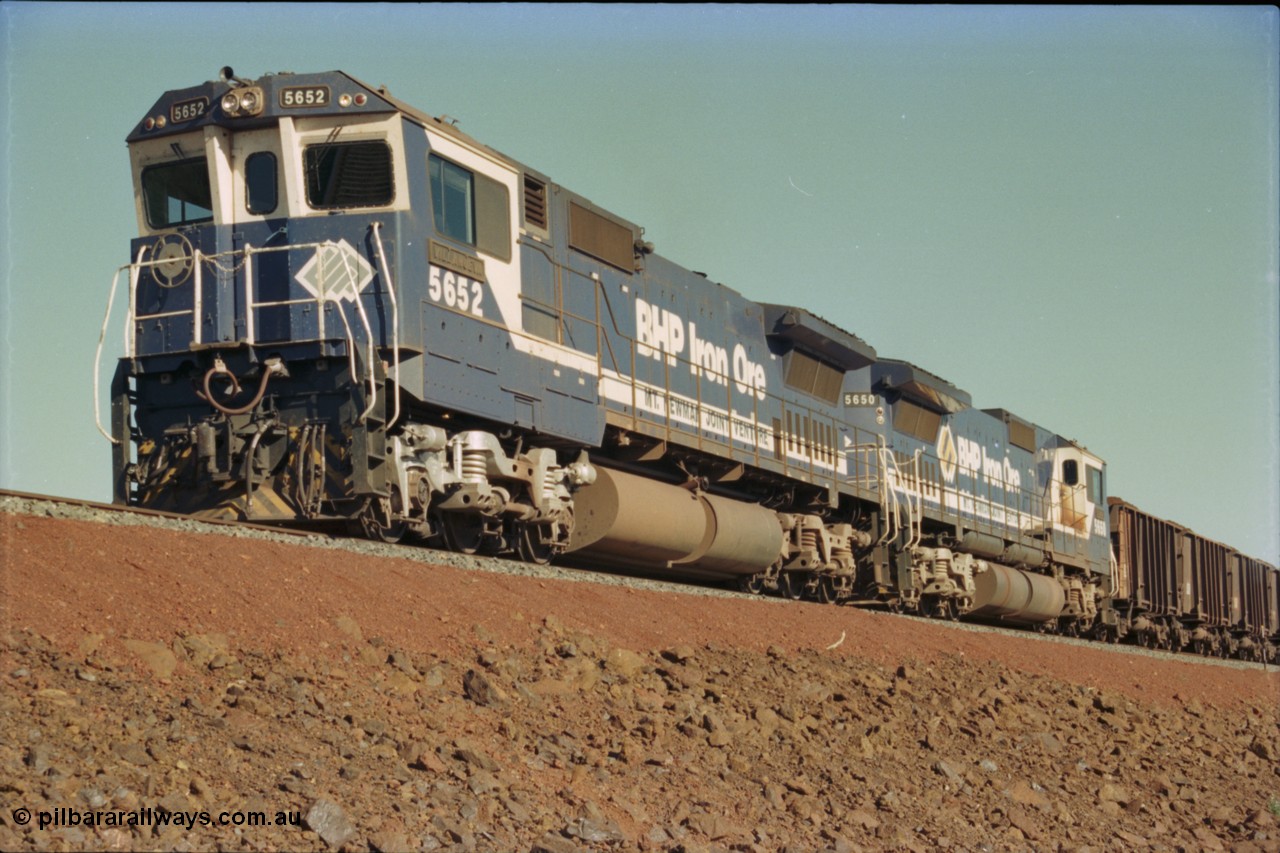 231-19
Yandi Two balloon loop, BHP Iron Ore 5652 'Villanueva' serial 8412-09 / 93-143 an Goninan WA rebuild CM40-8M GE unit loads a train at 1.2 km/h with second unit 5650. [url=https://goo.gl/maps/3vQHZqBXNa32]GeoData[/url].
Keywords: 5652;Goninan;GE;CM40-8M;8412-09/93-143;rebuild;AE-Goodwin;ALCo;M636C;5482;G6061-3;