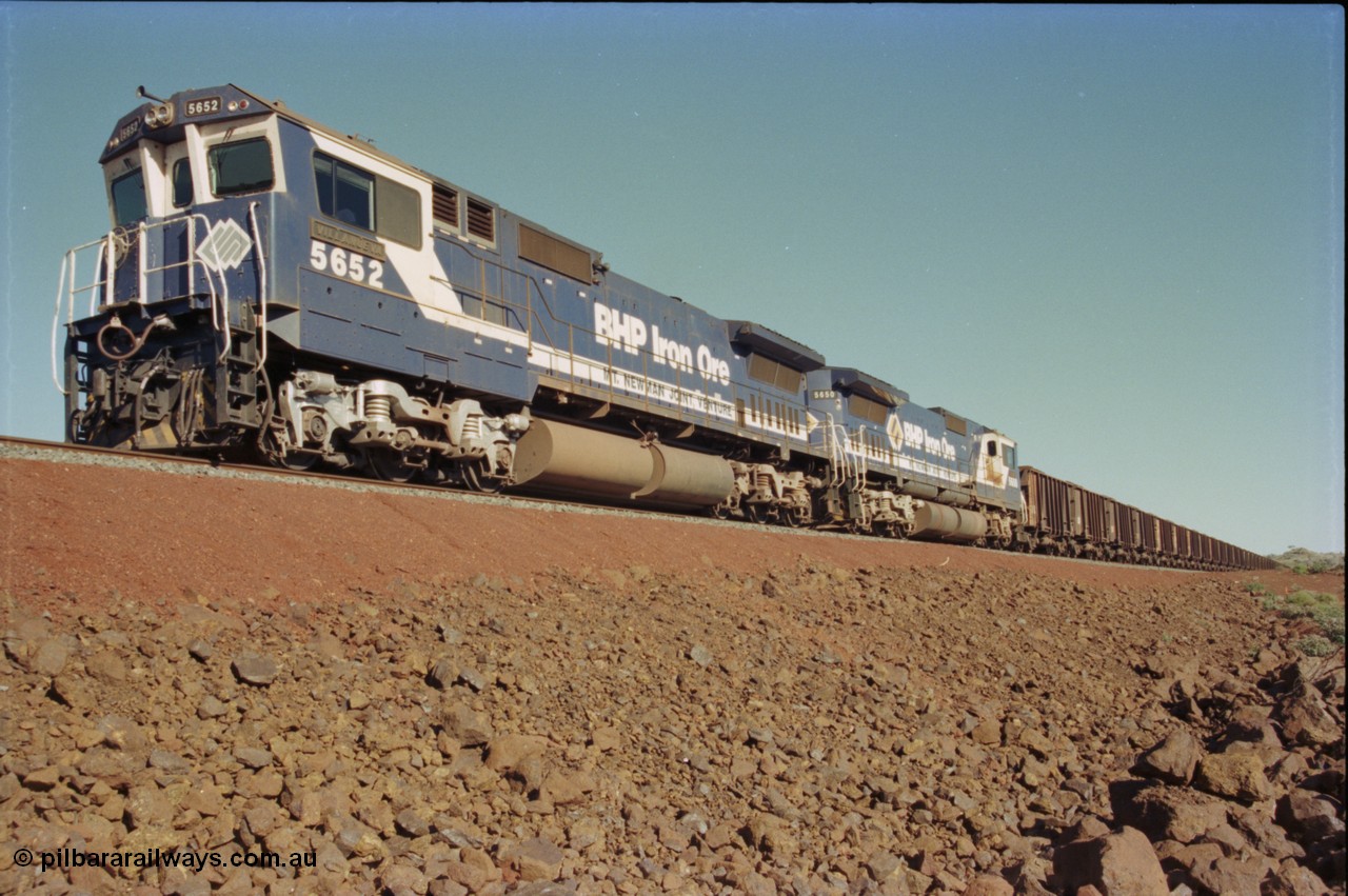 231-21
Yandi Two balloon loop, BHP Iron Ore 5652 'Villanueva' serial 8412-09 / 93-143 an Goninan WA rebuild CM40-8M GE unit loads a train at 1.2 km/h with second unit 5650. [url=https://goo.gl/maps/3vQHZqBXNa32]GeoData[/url].
Keywords: 5652;Goninan;GE;CM40-8M;8412-09/93-143;rebuild;AE-Goodwin;ALCo;M636C;5482;G6061-3;