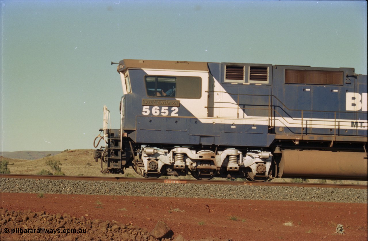 231-28
Yandi Two balloon loop, BHP Iron Ore 5652 'Villanueva' serial 8412-09 / 93-143 an Goninan WA rebuild CM40-8M GE unit loads a train at 1.2 km/h, note the missing logo from the hood and the round style fuel tanks tells us this units was rebuilt from an AE Goodwin built M636 ALCo. [url=https://goo.gl/maps/3vQHZqBXNa32]GeoData[/url].
Keywords: 5652;Goninan;GE;CM40-8M;8412-09/93-143;rebuild;AE-Goodwin;ALCo;M636C;5482;G6061-3;