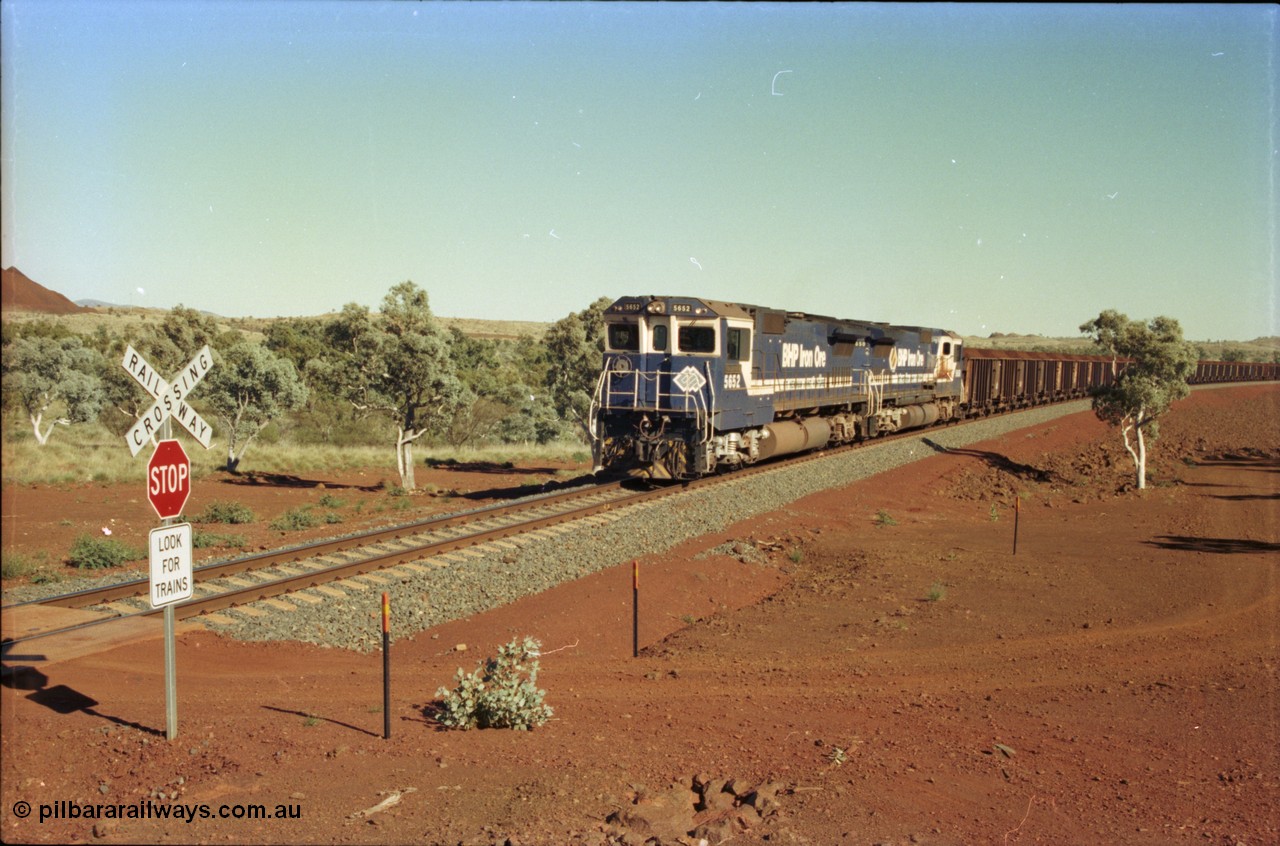 231-30
Yandi Two balloon loop 316.2 km grade crossing, BHP Iron Ore 5652 'Villanueva' serial 8412-09 / 93-143 an Goninan WA rebuild CM40-8M GE unit loads a train at 1.2 km/h with second unit 5650. [url=https://goo.gl/maps/N6VUeKeBS682]GeoData[/url].
Keywords: 5652;Goninan;GE;CM40-8M;8412-09/93-143;rebuild;AE-Goodwin;ALCo;M636C;5482;G6061-3;