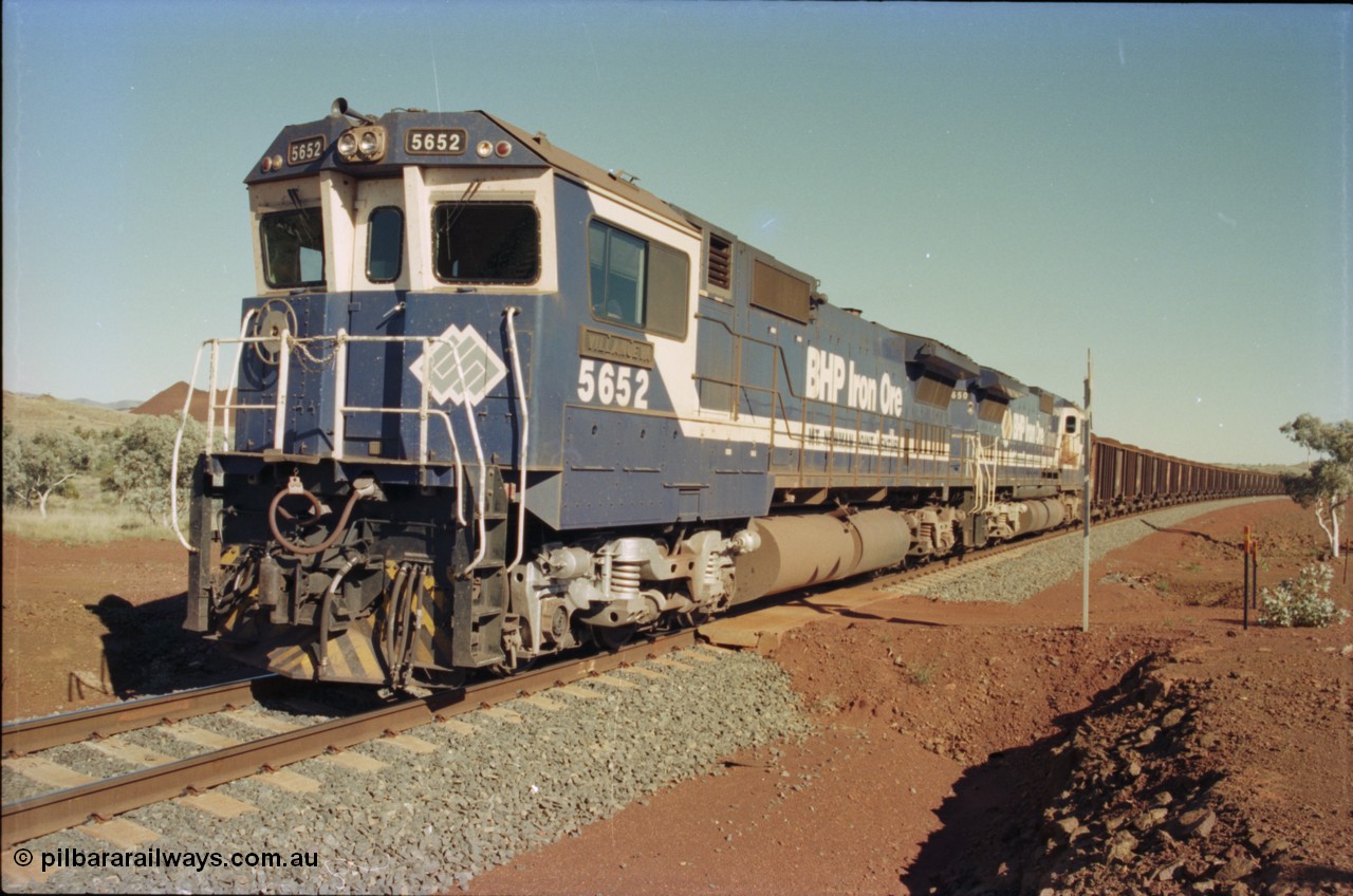 231-34
Yandi Two balloon loop 316.2 km grade crossing, BHP Iron Ore 5652 'Villanueva' serial 8412-09 / 93-143 an Goninan WA rebuild CM40-8M GE unit loads a train at 1.2 km/h with second unit 5650. [url=https://goo.gl/maps/N6VUeKeBS682]GeoData[/url].
Keywords: 5652;Goninan;GE;CM40-8M;8412-09/93-143;rebuild;AE-Goodwin;ALCo;M636C;5482;G6061-3;