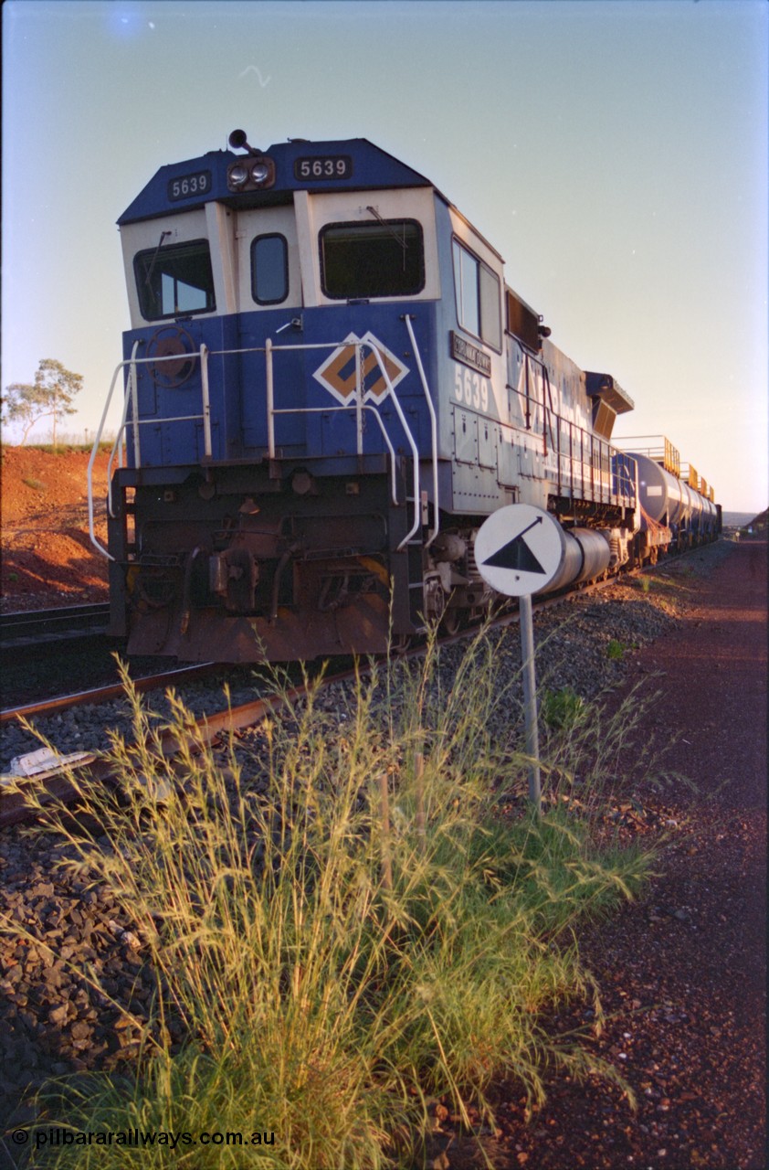 232-12
Yandi One backtrack, following a cyclone shutdown of the mainline and severe flooding around Yandi a 'mixed' freight train was operated to Yandi to deliver food, mail and diesel fuel to the mine and camp. Here BHP Iron Ore CM40-8M unit 5639 'Corunna Downs' serial 8281-03 / 92-128 idles away in the backtrack awaiting its path back to Port Hedland with flat waggon 6703, four fuel tank waggons and a broken ore waggon. February 1997. [url=https://goo.gl/maps/6c1WFqjYSg42]GeoData[/url].
Keywords: 5639;Goninan;GE;CM40-8M;8281-03/92-128;rebuild;AE-Goodwin;ALCo;C636;5459;G6027-3;