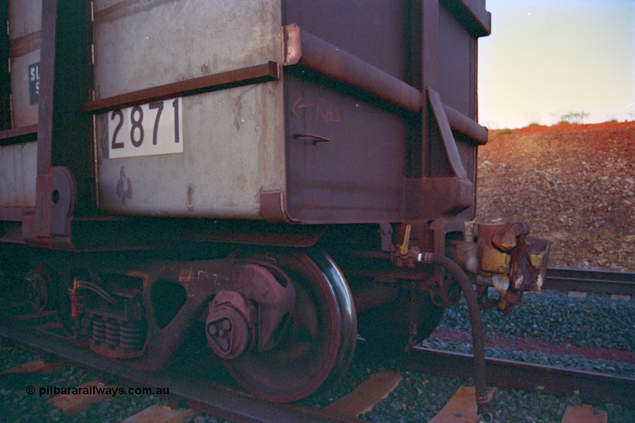 232-20
Yandi One backtrack, following a cyclone shutdown of the mainline and severe flooding around Yandi a 'mixed' freight train was operated to Yandi to deliver food, mail and diesel fuel to the mine and camp. Here BHP Iron Ore loaded Comeng WA built ore waggon 2871 has been re-sheeted with 3CR12 stainless steel side walls, view of broken coupler. February 1997. [url=https://goo.gl/maps/6c1WFqjYSg42]GeoData[/url].
Keywords: 2871;Comeng-WA;