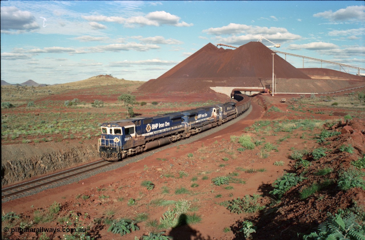 233-29
Yandi Two loaded car side of load-out tunnel, a loading train lead by BHP Iron Ore's Goninan rebuild CM40-8M GE unit 5650 'Yawata' serial 8412-07 / 93-141 as it drags the train through at 1.2 km/h with assistance from two sister units. [url=https://goo.gl/maps/gXRbfYH9U482]GeoData[/url].
Keywords: 5650;Goninan;GE;CM40-8M;8412-07/93-141;rebuild;AE-Goodwin;ALCo;M636C;5481;G6061-2;