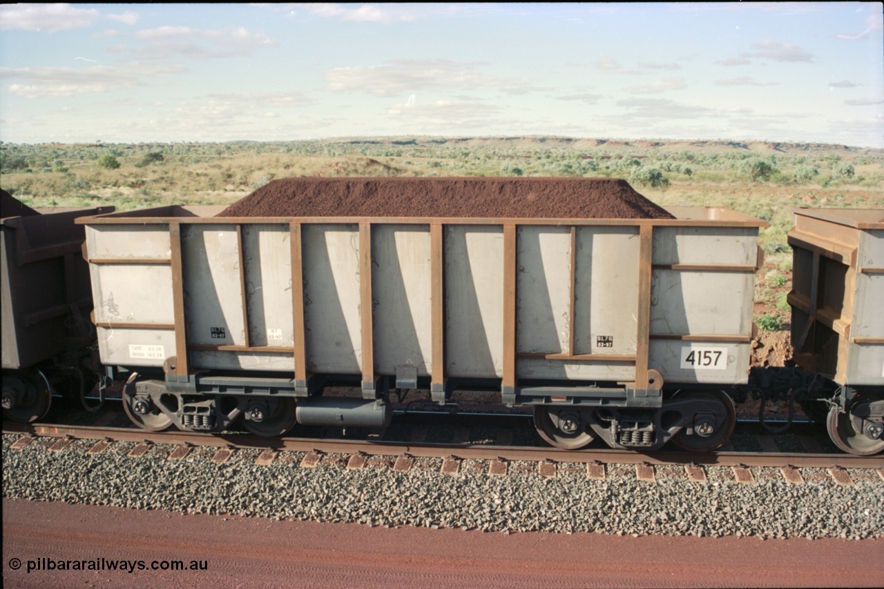 233-35
Yandi Two balloon loop, new United Goninan WA built iron ore waggon 4157, delivered in March 1997 as part of a batch of 126 waggons made from 3CR12 steel with tapered floors. [url=https://goo.gl/maps/gXRbfYH9U482]GeoData[/url].
Keywords: 4157;United-Goninan-WA;BHP-ore-waggon;