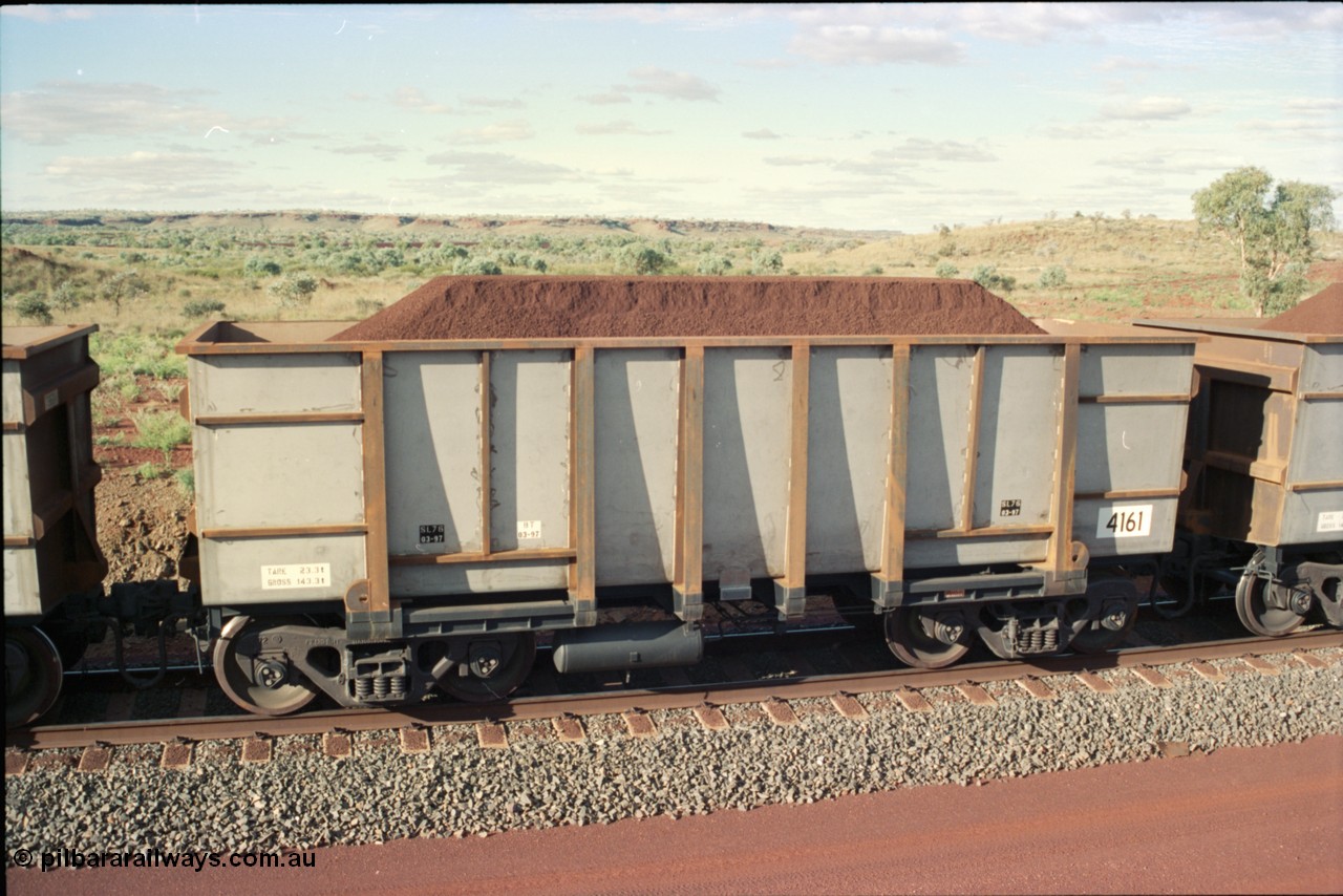 233-36
Yandi Two balloon loop, new United Goninan WA built iron ore waggon 4161, delivered in March 1997 as part of a batch of 126 waggons made from 3CR12 steel with tapered floors. [url=https://goo.gl/maps/gXRbfYH9U482]GeoData[/url].
Keywords: 4161;United-Goninan-WA;BHP-ore-waggon;