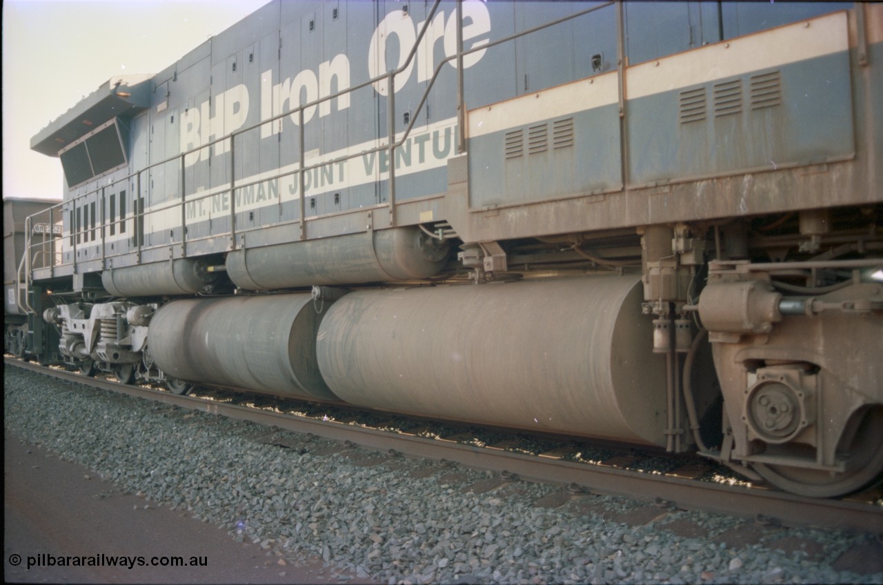234-14
Yandi Two, BHP Iron Ore Goninan rebuild CM40-8M GE unit 5640 'Ethel Creek' serial 8281-05 / 92-129 is on the rear of a 240 waggon loaded train, this configuration was trialled for a time with two Dash 8 locos, 120 waggons, Dash 8, 120 waggons and Dash 8. View of right hand side engine hood and fuel tank. Circa 1998.
Keywords: 5640;Goninan;GE;CM40-8M;8281-05/92-129;rebuild;AE-Goodwin;ALCo;M636C;5479;G6047-11;