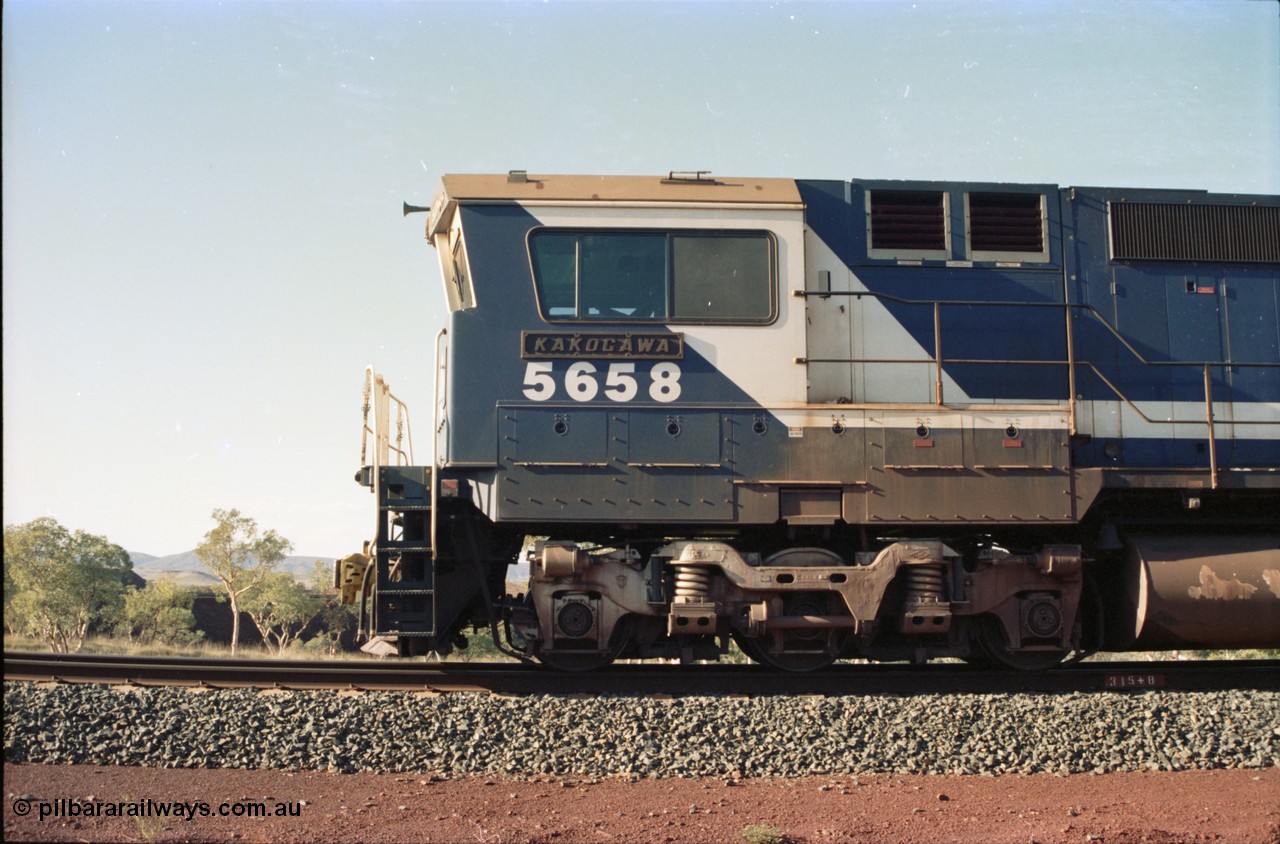 234-30
Yandi Two, BHP Iron Ore Goninan rebuild CM40-8M GE unit 5658 'Kakogawa' serial 8412-03 / 94-149 on the front of a 240 waggon loaded train, this configuration was trialled for a time with two Dash 8 locos, 120 waggons, Dash 8, 120 waggons and Dash 8. Left hand side cab view. Circa 1998.
Keywords: 5658;Goninan;GE;CM40-8M;8412-03/94-149;rebuild;AE-Goodwin;ALCo;M636C;5480;G6061-1;
