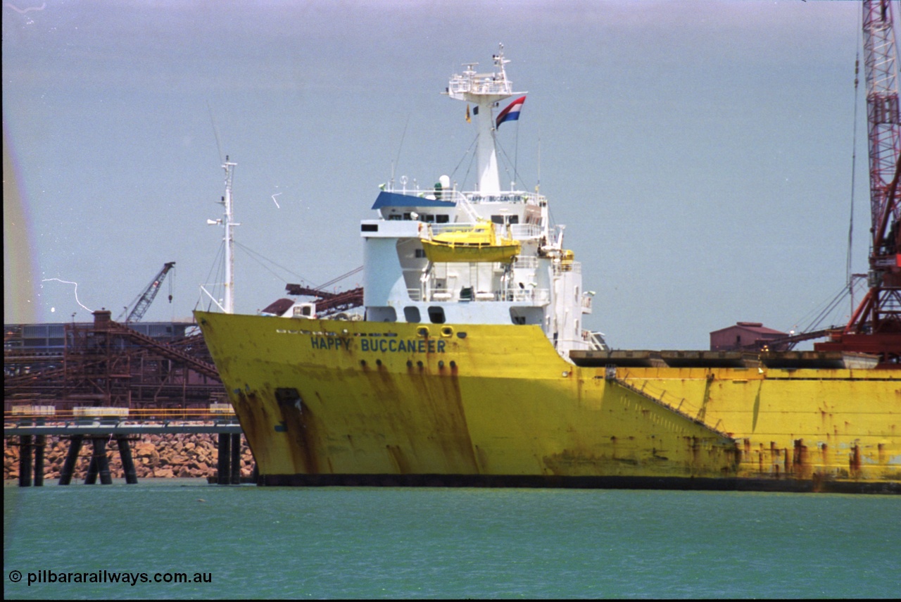 238-06
Port Hedland Harbour, heavy lift ship Happy Buccaneer (IMO: 8300389) sits at Finucane Island D Berth delivering a new shiploader for BHP Billiton. 1st November 2003. [url=https://goo.gl/maps/vWZoHTsRPsp] Geodata [/url]. Back in time here the ship cranes were only 550 tonne each, these are now 700.
Keywords: Happy-Buccaneer;Hitachi-Shipbuilding-Osaka-Japan;