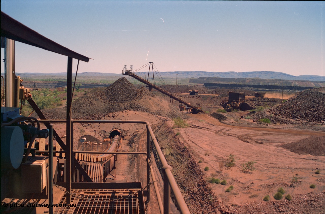 239-16
View of Yandi One OHP looking from the secondary crusher west back to the primary crusher system with CV3 and the reclaim tunnel and the pedestal mount for CV2 evident. The mine, trucks and waste dump can be seen in the background. [url=https://goo.gl/maps/gpgfApaAJYt]GeoData[/url].
