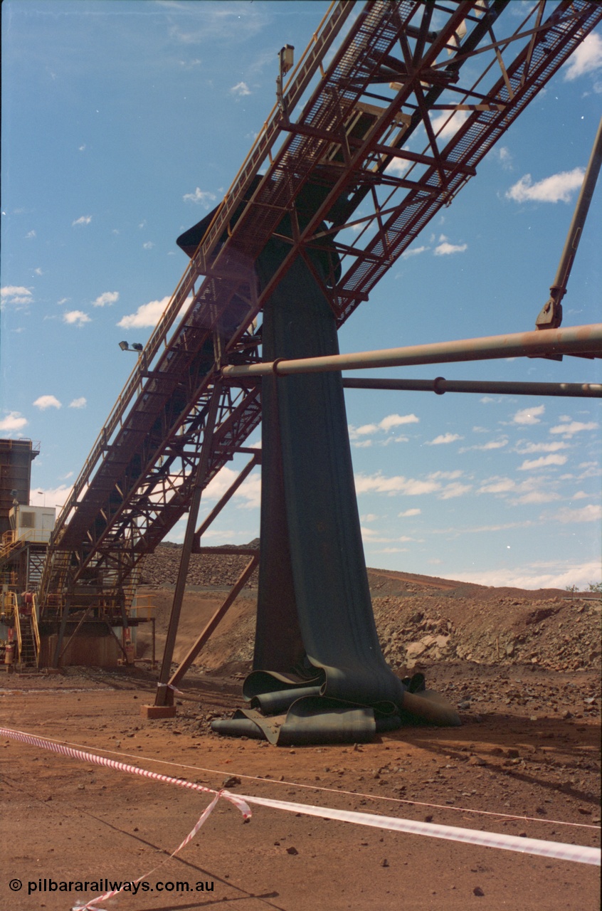 239-31
Yandi Two, conveyor belt CV202 failure to the belt on the primary crushing circuit. Shows belt rolls dropped to ground, primary crusher control cabin, ROM bin and drive platform visible. [url=https://goo.gl/maps/8JjZk3duhKu]GeoData[/url].
