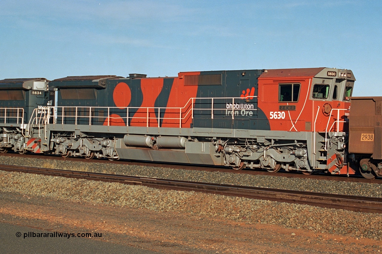 243-05
Nelson Point departure yard, BHP Billiton's CM39-8 unit 5630 'Zeus' serial 5831-09 / 88-079 and built new by Goninan trails CM40-8M unit 5634 both in the new 'earth' or 'bubble' livery as they head up an empty train waiting departure time. August 2003.
Keywords: 5630;Goninan;GE;CM39-8;5831-09/88-079;