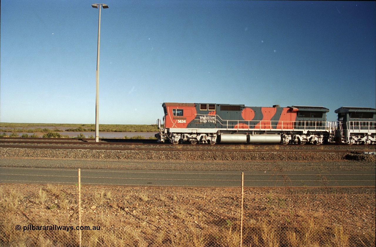 243-15
Nelson Point departure yard, BHP Billiton's CM40-8M unit 5634 'Boodarie' a Goninan WA GE rebuild unit serial 8151-07 / 91-120 in the new 'earth' or 'bubble' livery as it heads up an empty train waiting departure time. August 2003.
Keywords: 5634;Goninan;GE;CM40-8M;8151-07/91-120;rebuild;AE-Goodwin;ALCo;C636;5457;G6027-1;