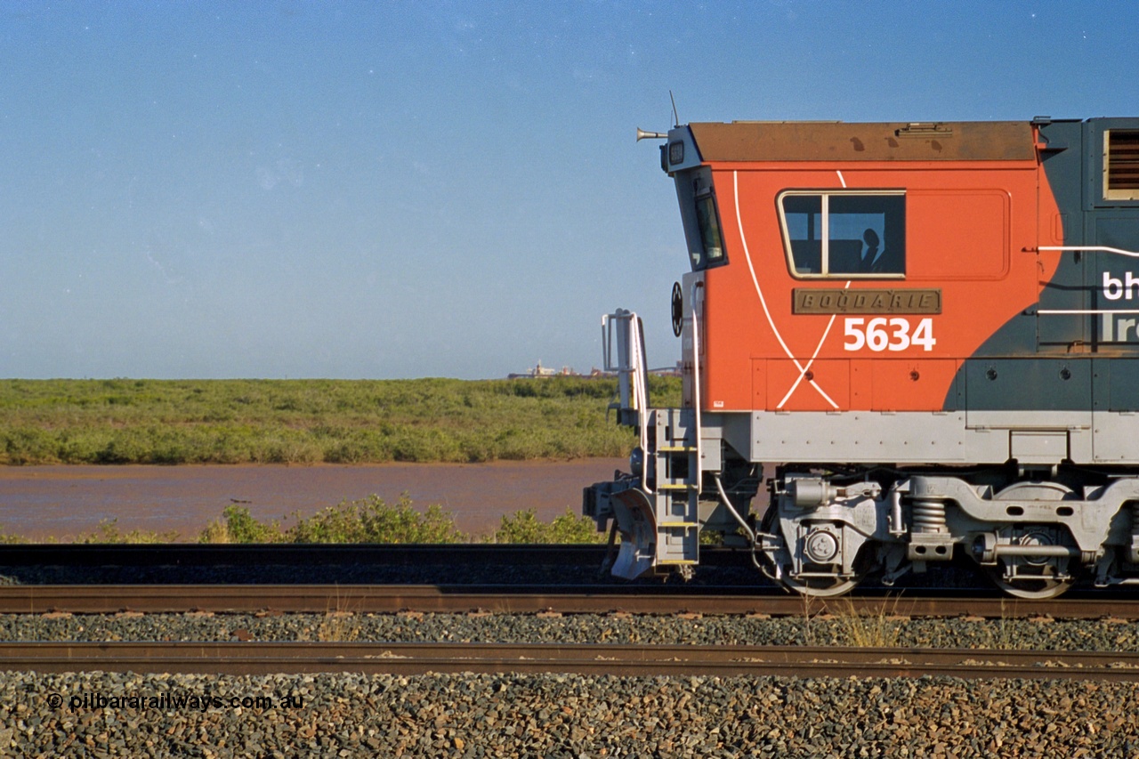 243-36
Nelson Point departure yard, BHP Billiton's CM40-8M unit 5634 'Boodarie' a Goninan WA GE rebuild unit serial 8151-07 / 91-120 in the new 'earth' or 'bubble' livery as it heads up an empty train waiting departure time. August 2003. The view to the left is much changed as FMG now has five berths along with Roy Hill and BHP Harriet Point.
Keywords: 5634;Goninan;GE;CM40-8M;8151-07/91-120;rebuild;AE-Goodwin;ALCo;C636;5457;G6027-1;