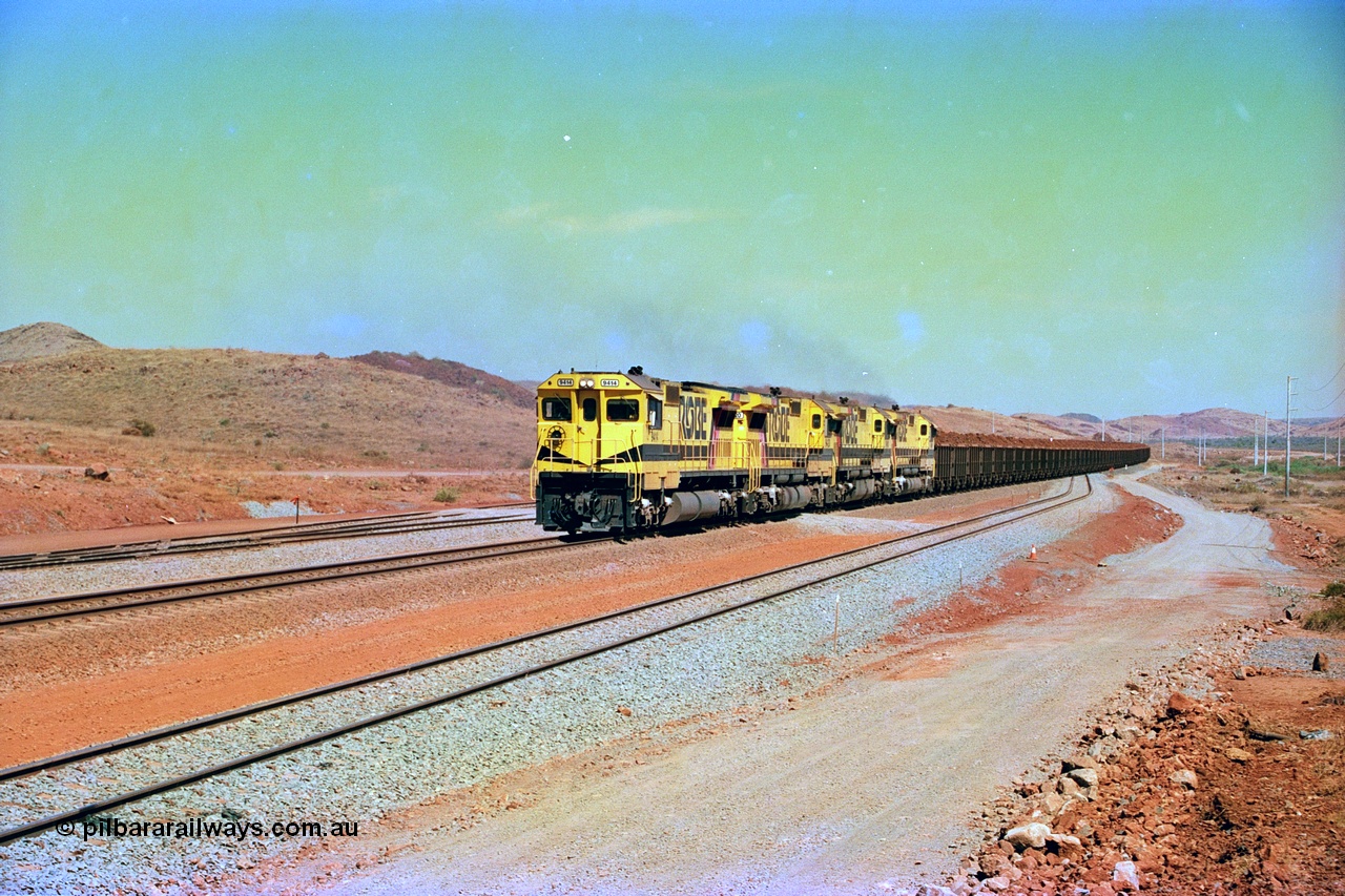 246-17
Cape Lambert, yard view of the then new extension to the south for the West Angelas mine was coming on stream as a Robe River loaded Deepdale train arrives on the main behind the standard quad Dash 8 power with 202 waggons. 9414 which is a Goninan WA ALCo to GE rebuild CM40-8M with serial 8206-11 / 91-124 from November 1991 and was originally an AE Goodwin built M636 ALCo built new for Robe in December 1971 and numbered 262.005, later numbered 1714. 22nd May 2002.
Keywords: 9414;Goninan;GE;CM40-8M;8206-11/91-124;rebuild;AE-Goodwin;ALCo;M636;G6060-5;
