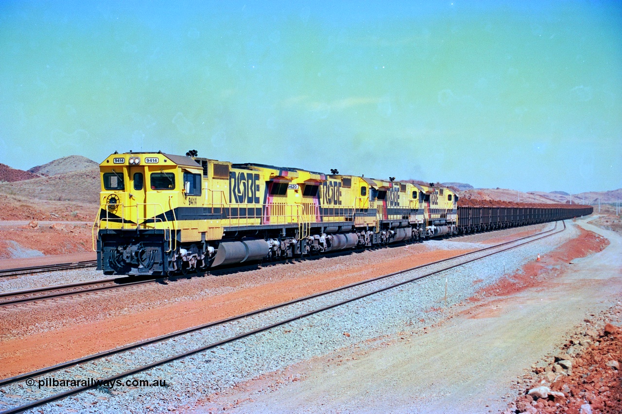 246-19
Cape Lambert, a Robe River loaded Deepdale train arrives on the main behind the standard quad Dash 8 power with 202 waggons. 9414 which is a Goninan WA ALCo to GE rebuild CM40-8M with serial 8206-11 / 91-124 from November 1991 riding on Dofasco bogies and was originally an AE Goodwin built M636 ALCo built new for Robe in December 1971 and numbered 262.005, later numbered 1714. 22nd May 2002.
Keywords: 9414;Goninan;GE;CM40-8M;8206-11/91-124;rebuild;AE-Goodwin;ALCo;M636;G6060-5;