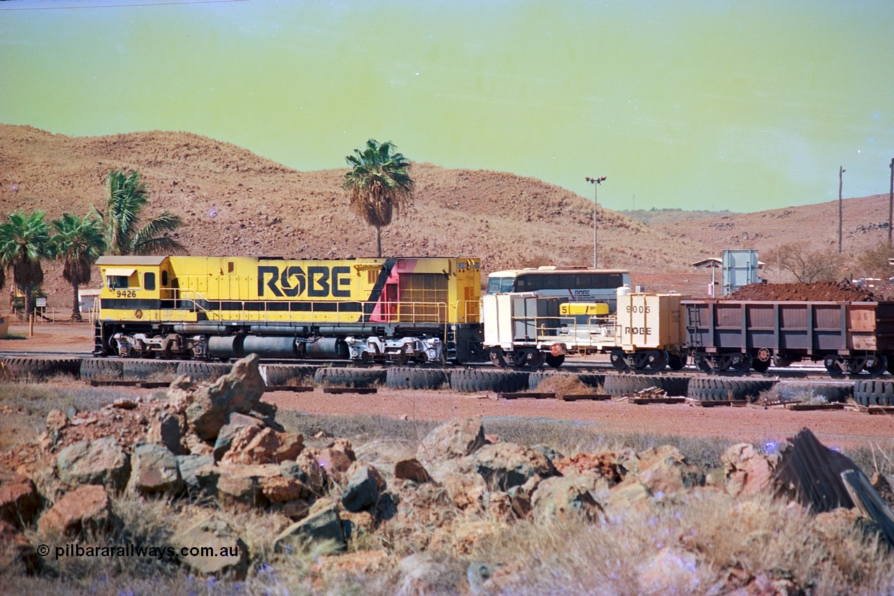 247-02
Cape Lambert, Robe River's 9426 a Comeng WA rebuild from ALCo Schenectady NY model C636 serial 3499-3 originally built in January 1968 for Pennsylvania as #6332, Penn Central 6332 and finally Conrail 6782. Purchased in 1986 and rebuilt by Comeng WA into C636R before delivery to Robe in November 1986. This loco also went on to become DR 8401 for construction of FMG's railway in 2007-08. Seen here in the South Yard waiting to drag a loaded rake down to the car dumper. Approximate location of train is [url=https://goo.gl/maps/tRtaJxMULpjBhtqa8]here[/url]. 22nd May 2002.
Keywords: 9426;Comeng-WA;C636R;WA143-1;rebuild;ALCo;Schenectady-NY;C636;Conrail;6782;3499-3;