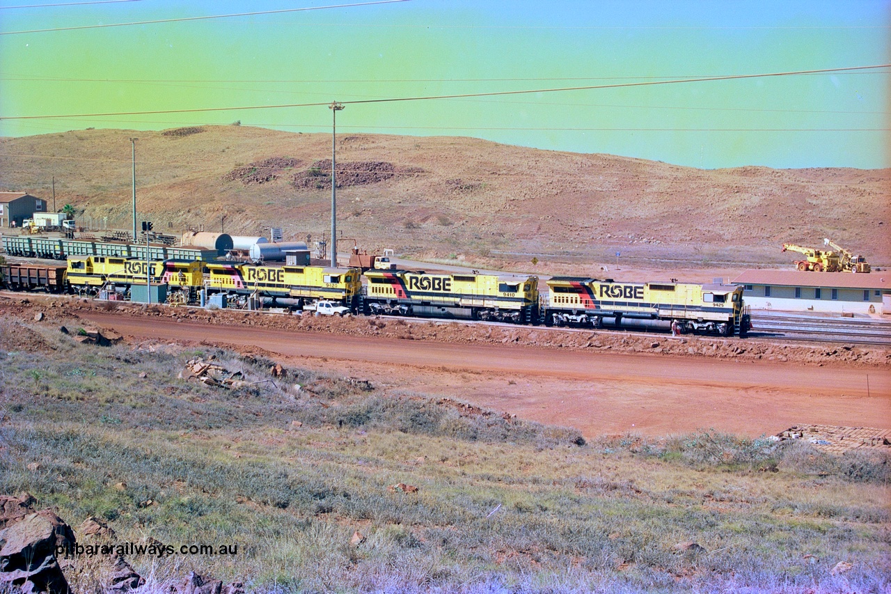 247-17
Cape Lambert overview of the fuel point, with a brace of four CM40-8M rebuilds finishing up refuelling before departing with another empty train. The workshops are to the left of the picture. Where I'm standing to take the picture is now all stockpile. Approximate location of photo is [url=https://goo.gl/maps/B9F4estGGPbd2GrB6]here[/url]. 22nd May 2002.
Keywords: 9425;Goninan;GE;CM40-8M;6266-8/89-85;rebuild;AE-Goodwin;ALCo;M636;G-6041-4;
