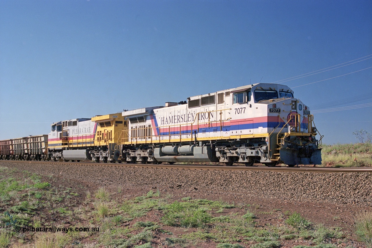 248-01
Dingo Siding on the Hamersley Iron railway at the 39 km with an empty train headed up by a pair of General Electric built Dash 9-44CW units 7077 serial 47756 from the original first order in the Pepsi Can livery and 9408 serial 54158 from the fourth order in the Pilbara Rail livery with Robe ownership markings. Approximate [url=https://goo.gl/maps/Jv752bD5KXv28oUV7]location[/url]. 24th April 2004.
Keywords: 7077;GE;Dash-9-44CW;47756;