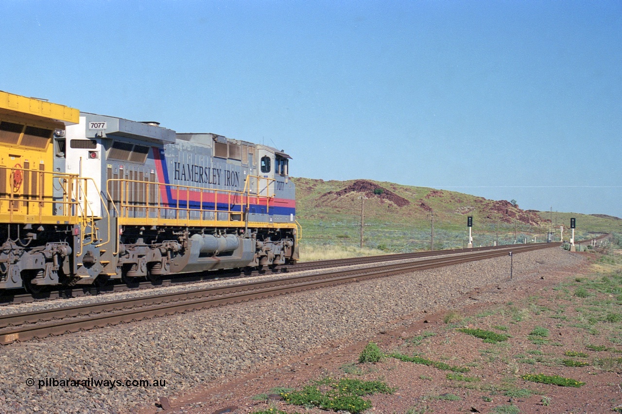248-12
Dingo Siding on the Hamersley Iron railway at the 39 km with an empty train headed up by a pair of General Electric built Dash 9-44CW units 7077 serial 47756 from the original first order in the Pepsi Can livery and 9408 serial 54158 from the fourth order in the Pilbara Rail livery with Robe ownership markings powers away to the south with the signal marker boards are in the distance. Approximate [url=https://goo.gl/maps/Jv752bD5KXv28oUV7]location[/url]. 24th April 2004.
Keywords: 7077;GE;Dash-9-44CW;47756;