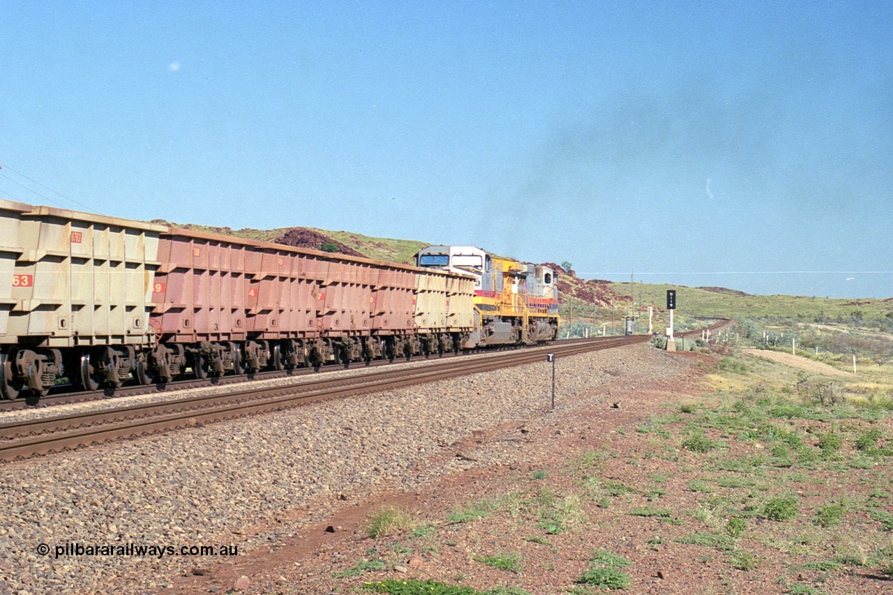 248-13
Dingo Siding on the Hamersley Iron railway at the 39 km with an empty train headed up by a pair of General Electric built Dash 9-44CW units 7077 serial 47756 from the original first order in the Pepsi Can livery and 9408 serial 54158 from the fourth order in the Pilbara Rail livery with Robe ownership markings powers away to the south with the signal marker boards are in the distance. Approximate [url=https://goo.gl/maps/Jv752bD5KXv28oUV7]location[/url]. 24th April 2004.
